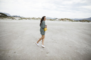 South Africa, Western Cape, Noordhoek, happy woman on the beach - DAWF00676