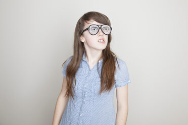 Girl wearing fake glasses grimacing - ISF18651
