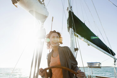 Young woman steering yacht - ISF18705