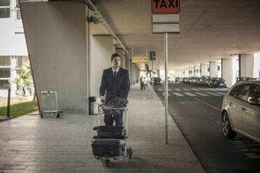 Young man with luggage trolley in airport - ISF18747