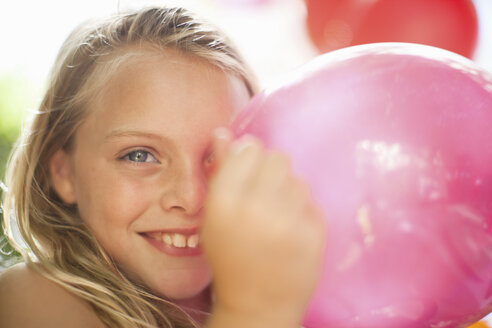 Lächelndes Mädchen hält Luftballon auf Party - ISF18759
