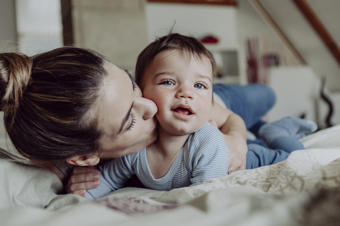 Mother cuddling with her baby son stock photo