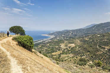 Greece, Peloponnese, Egira, Aigeira, female hiker on hiking path - MAMF00164