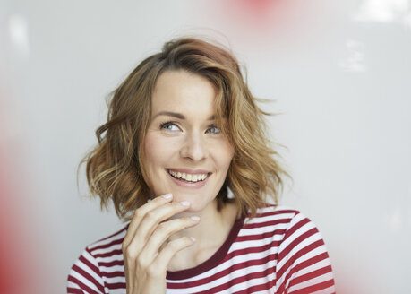 Portrait of smiling woman wearing red-white striped t-shirt - PNEF00776