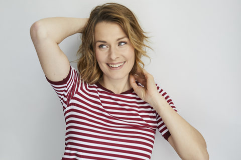 Portrait of smiling woman wearing red-white striped t-shirt stock photo