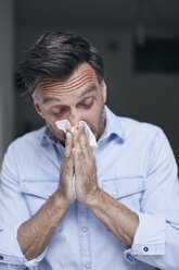 Portrait of man blowing nose - PNEF00832