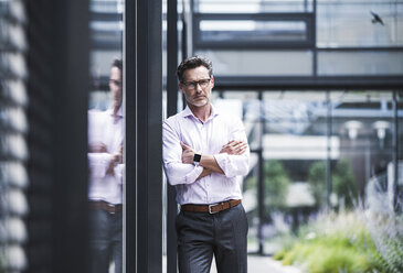 Portrait of serious businessman outside office building - UUF14671