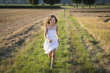 Happy little girl running in nature - LVF07356