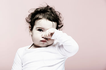 Portrait of baby girl rubbing eyes - ISF19088