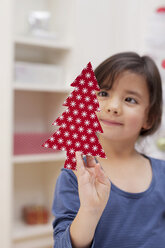 Girl holding Christmas tree decoration - ISF19341