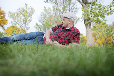 Young man lying on grass in park - ISF19404