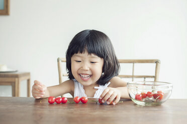 Girl with bowl of cherries - ISF19427