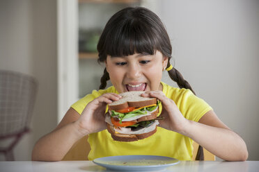 Girl biting into sandwich - ISF19518