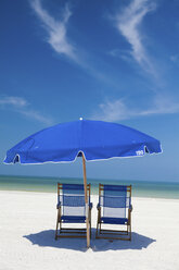 Deckchairs and parasol on beach, Clearwater, Florida, United States - ISF19533