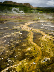 Steam rising from hot springs near a Geyser in an area of geothermal activity - MINF03087