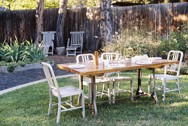 A table in a garden laid for a meal. - MINF03239