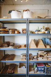 Shelves in a wood turner's workshop and a display of smooth wooden blocks and round platters and bowls. - MINF03543