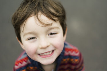 A boy looking up at the camera and smiling. - MINF03615