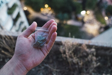 Young man with cannabis in hand - KKAF01332