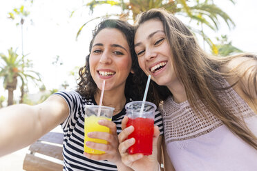 Portrait of two happy female friends enjoying a fresh slush - WPEF00764