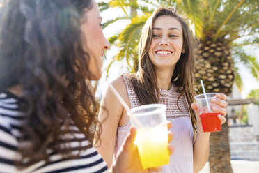 Two happy female friends enjoying a fresh slush - WPEF00768