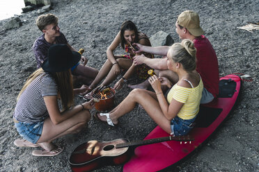 Group of friends sitting together having a barbecue - UUF14836