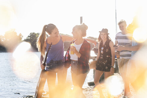 Group of happy friends walking at the riverside - UUF14872