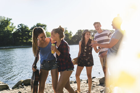 Group of happy friends walking at the riverside - UUF14873