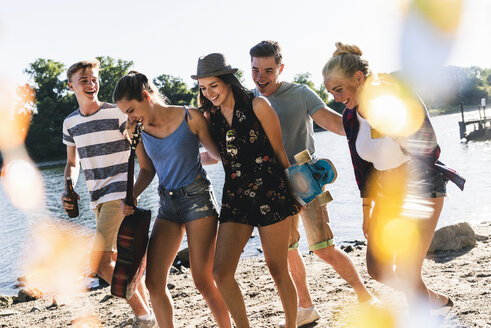 Group of happy friends walking at the riverside - UUF14876