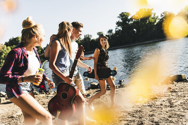 Group of happy friends walking at the riverside - UUF14879