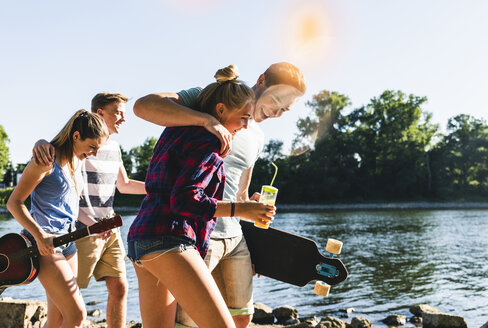 Group of happy friends walking at the riverside - UUF14881