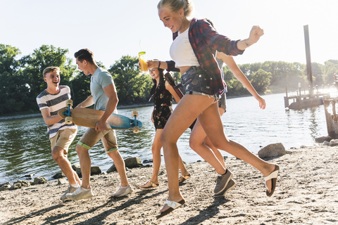 Group of happy friends having fun at the riverside stock photo