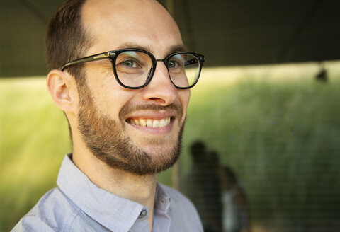 Portrait of smiling businessman wearing glasses - NGF00479