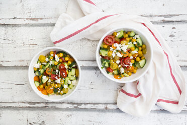 Bowl of salad with chick peas roasted with curcuma, feta, cucumber, tomatoes and parsley - LVF07367