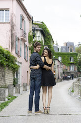 France, Paris, young couple in an alley in the district Montmartre - AFVF01249