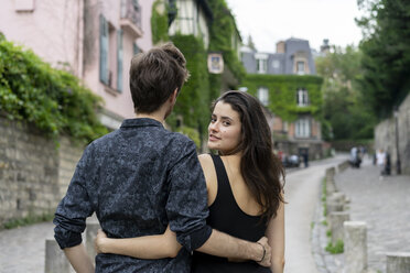 France, Paris, young couple in an alley in the district Montmartre - AFVF01250