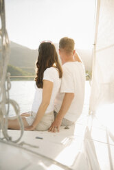 Woman and teenage girl sitting on a sail boat. - MINF04691