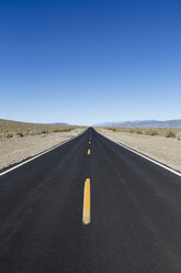 A black top road with a central line reaching into the distance, the road ahead. - MINF04756