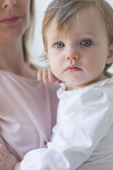 Close up of a young girl in her mother's arms. - MINF04878