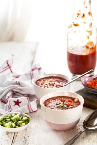 Schale Gazpacho mit Gurke und Paprika als Topping, lizenzfreies Stockfoto