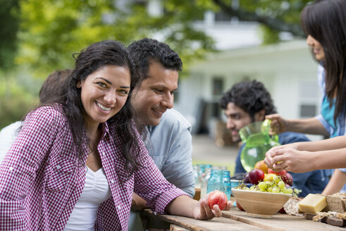 A summer party outdoors. Friends around a table. - MINF04918