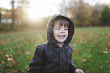 A child, boy playing in the park surrounded by autumn leaves. - MINF05063