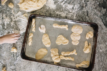 High angle view of baking tray with biscuit dough in various shapes. - MINF05245