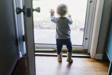 Toddler, girl, standing and pushing a screen door. - MINF05367