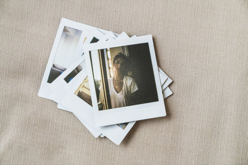 Stack of instant photos of young woman - KKAF01450