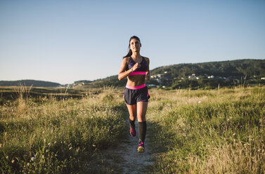 Sportswoman jogging on path - RAEF02062