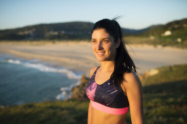 Portrait of an athlete woman in the evening, beach in the background - RAEF02066