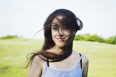 Portrait of a smiling young woman with long brown hair. - MINF05657