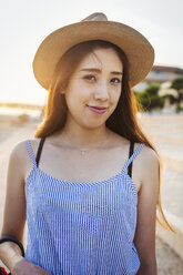 Smiling young woman with long brown hair, wearing Panama hat. - MINF05760