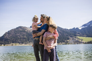 Austria, Tyrol, Walchsee, happy family at the lake - JLOF00153